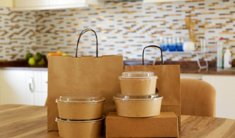 Kosher food delivery packaged in brown recyclable tupperware and paper bags