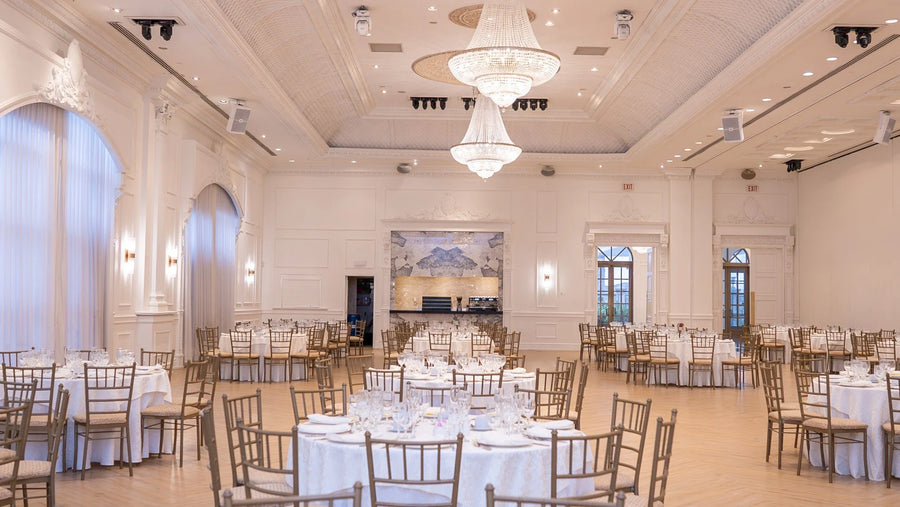 Large banquet hall with tables, chairs, and chandeliers