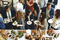 a corporate holiday event with a spread of kosher catered food 