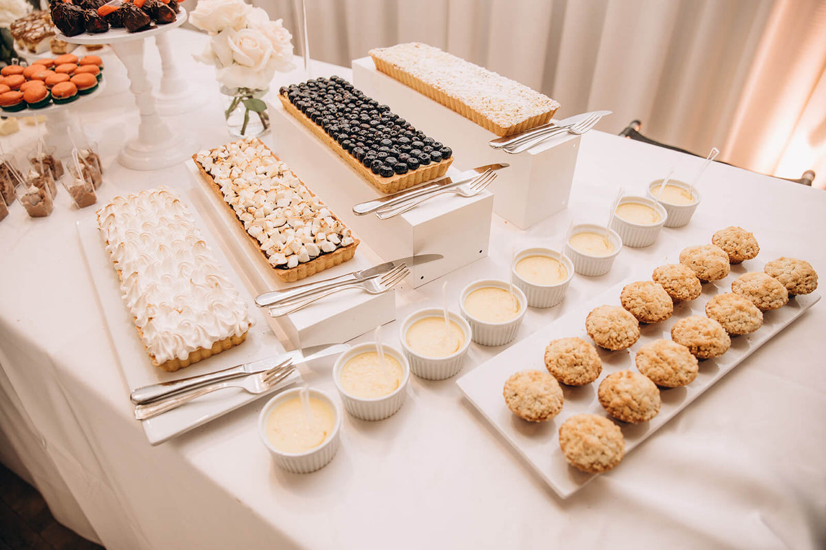 an assortment of desserts on display at an event catered by Ely's Find Foods