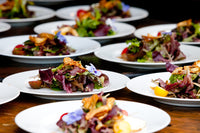 Salad appetizer plated beautifully with edible flowers